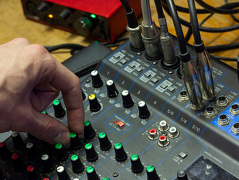 Hand adjusting an audio system