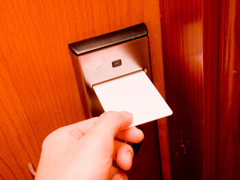 Hotel card key being inserted into door lock
